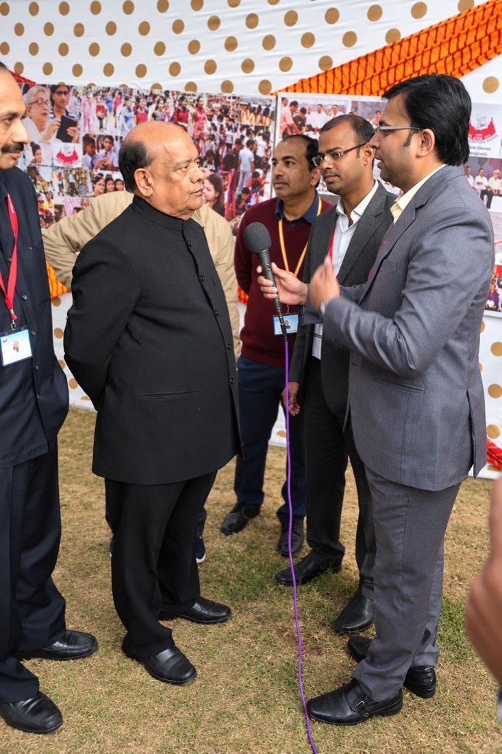 Niranjan Mahawar conducting an interview at a public event