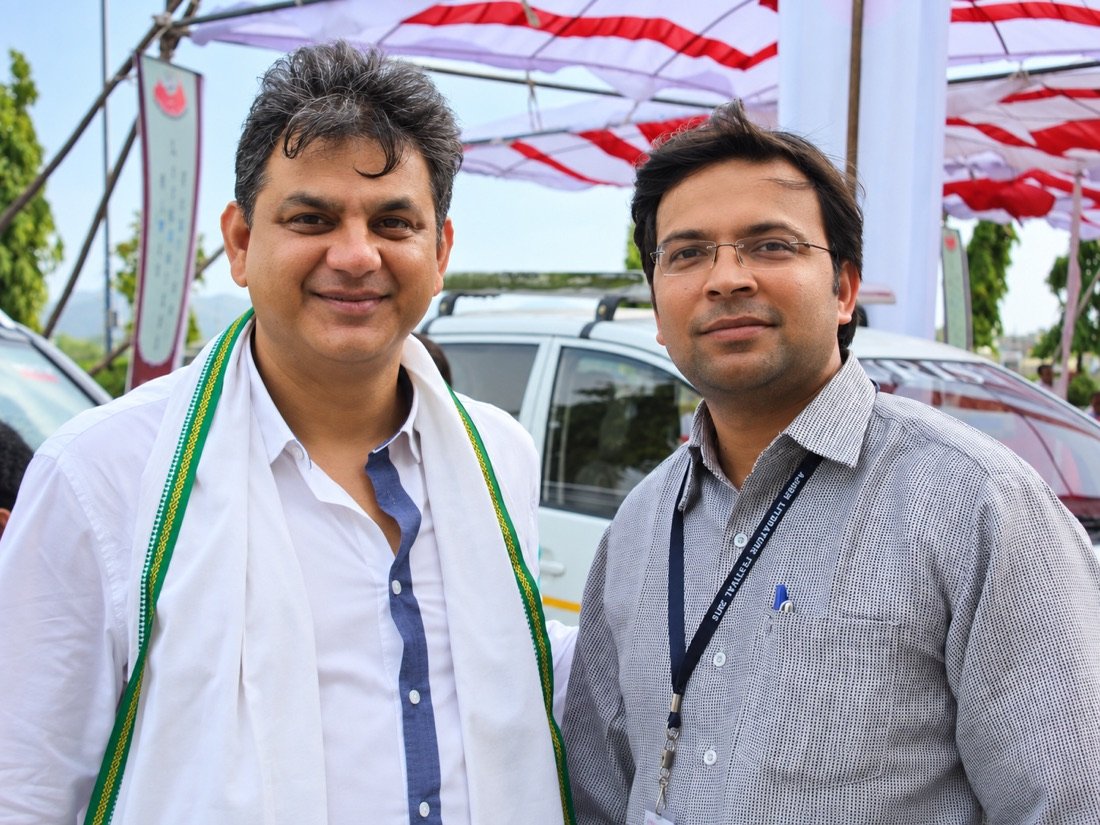 Niranjan Mahawar meeting a guest at an outdoor event