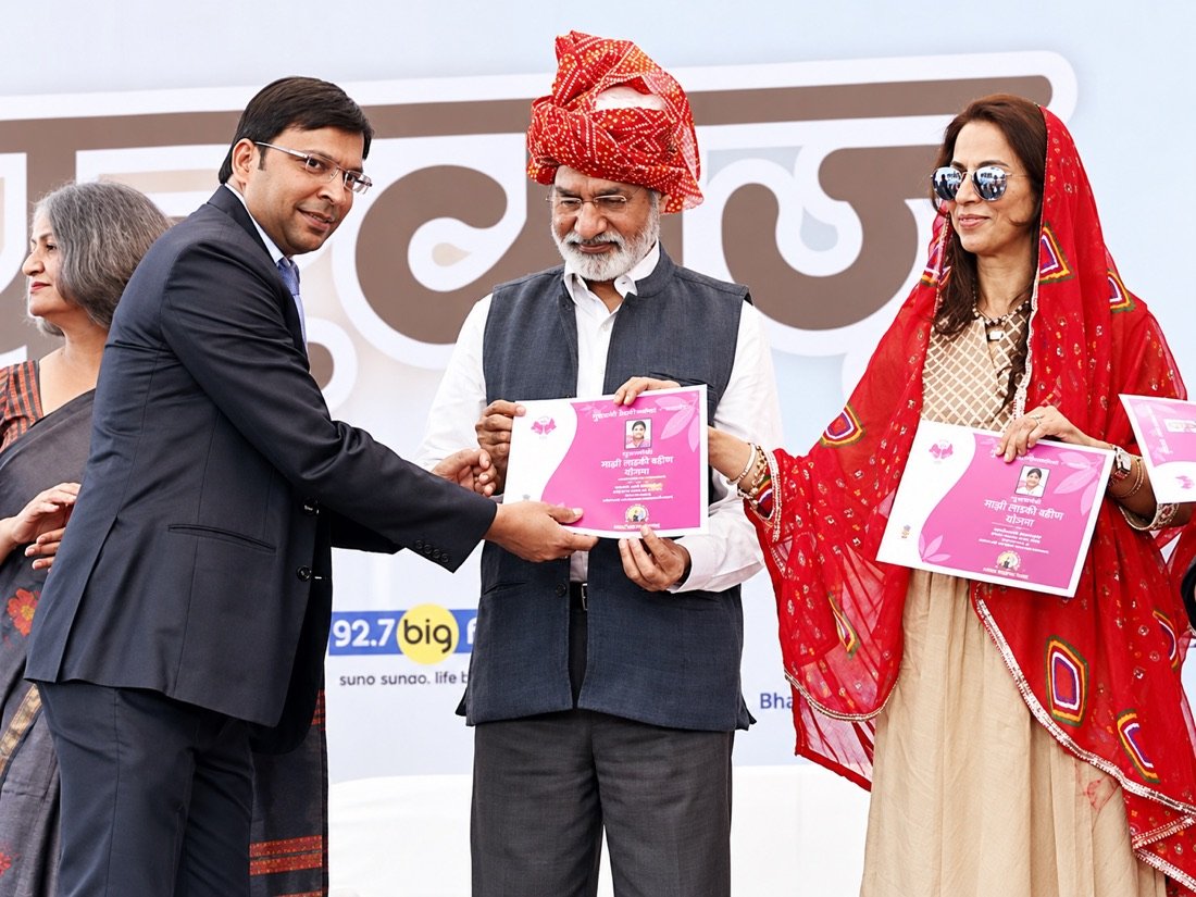 Niranjan Mahawar presenting a publication during a public ceremony
